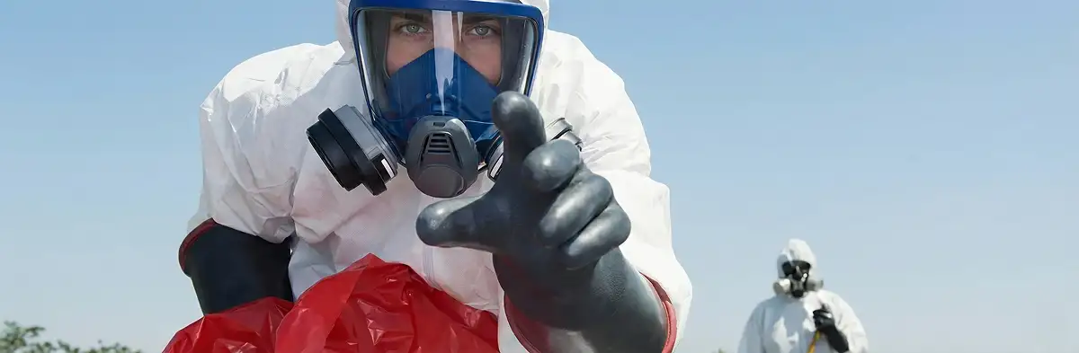 sewage clean up technician wearing protective gear handling biohazard materials in Memphis, TN